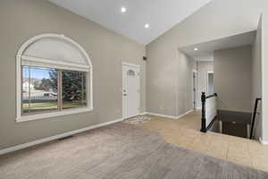 Tiled entrance foyer with high vaulted ceiling