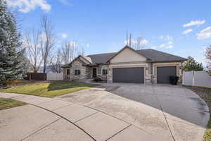 View of front of house featuring a garage and a front yard