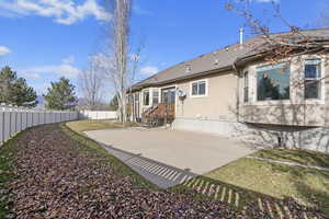 Rear view of property featuring a patio area and a lawn