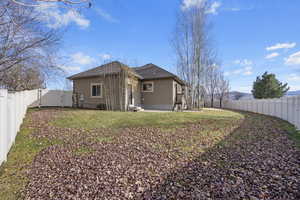 Rear view of property with a yard