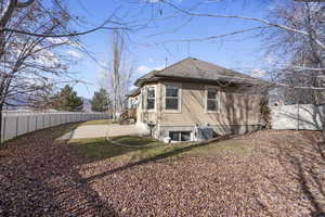 View of home's exterior featuring a patio area and a yard