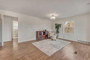 Living area featuring a chandelier and hardwood / wood-style flooring