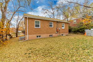 Rear view of house with a yard