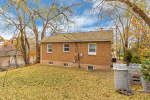 Rear view of house with a yard