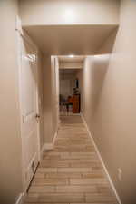 Hallway with light hardwood / wood-style flooring