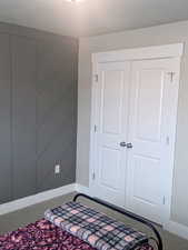 Bedroom with a textured ceiling and a closet