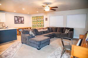 Living room featuring ceiling fan, light hardwood / wood-style flooring, and sink