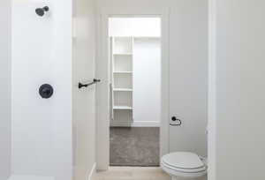 Bathroom with wood-type flooring and toilet