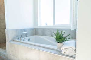 Bathroom featuring tiled bath