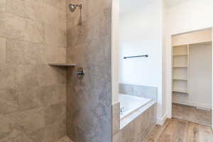 Bathroom featuring independent shower and bath and hardwood / wood-style flooring