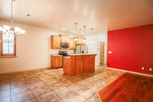 Kitchen featuring a center island, stainless steel appliances.