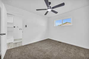 Empty room featuring carpet and ceiling fan