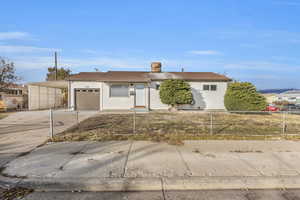 Single story home featuring a carport and a garage