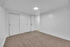 Unfurnished bedroom with carpet and a closet