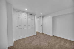 Unfurnished bedroom with carpet flooring, a textured ceiling, and a closet