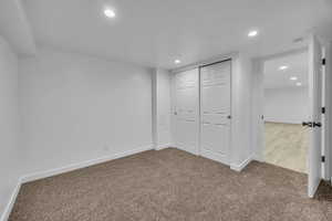 Unfurnished bedroom with a closet and carpet floors