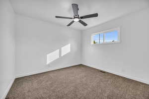 Empty room featuring carpet and ceiling fan