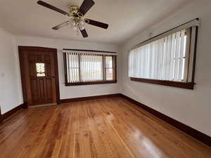 Entryway with ceiling fan and light hardwood / wood-style flooring