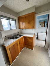 Kitchen featuring decorative backsplash and sink