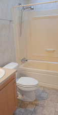 Full bathroom with vanity, toilet, and washtub / shower combination