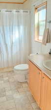 Full bathroom with vanity, shower / tub combo, and toilet