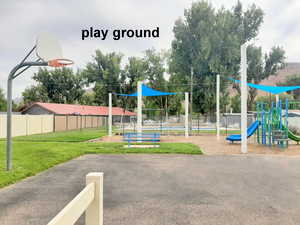 View of play area with a lawn and basketball court