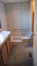 Bathroom with vanity and a bath