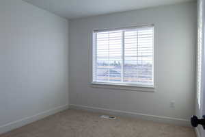 Unfurnished room with carpet flooring