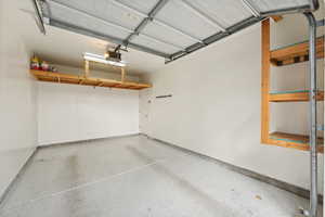 Garage featuring extra height, storage, and a garage door opener