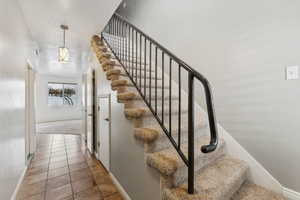 Staircase featuring tile patterned floors