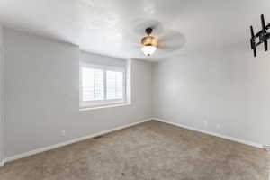 Spare room with carpet flooring and ceiling fan