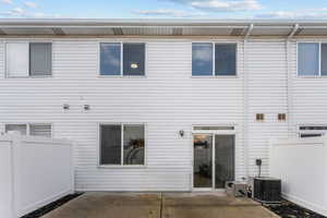 Back of house with a patio and central AC unit