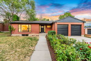 View of front of house featuring a yard and a garage