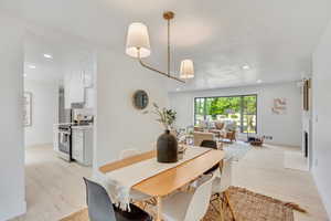 Dining area featuring light hardwood / wood-style flooring and a notable chandelier