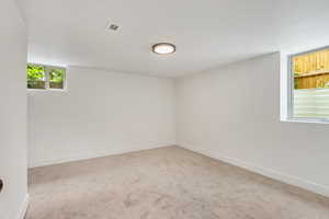 Spare room featuring light colored carpet