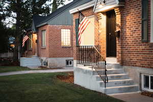 Doorway to property featuring a yard