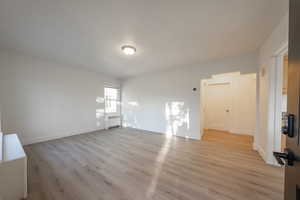 Interior space featuring light wood-type flooring and radiator