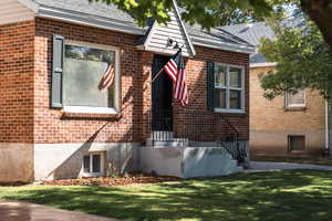 View of exterior entry with a lawn