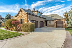 French country home featuring a garage