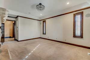 Unfurnished room with light carpet and ornamental molding