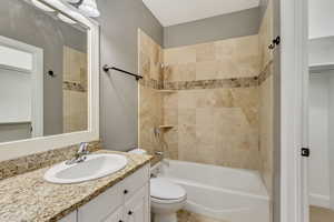 Full bathroom featuring tile patterned floors, vanity, toilet, and tiled shower / bath