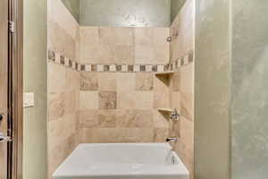 Bathroom featuring tiled shower / bath