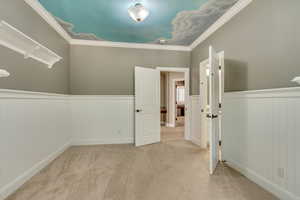 Interior space with light colored carpet and ornamental molding