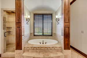 Bathroom with separate shower and tub and vaulted ceiling