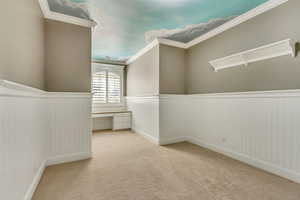 Spacious closet with light carpet