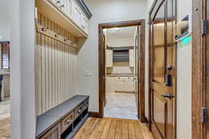 Mudroom with light hardwood / wood-style flooring