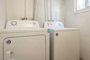 Washroom with washer and clothes dryer