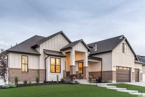 Modern farmhouse featuring a garage and a front yard