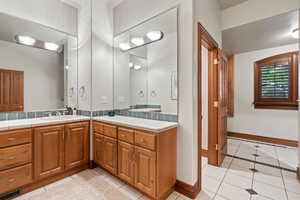 Bathroom with vanity and tile patterned floors