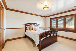 Carpeted bedroom featuring ornamental molding and a textured ceiling